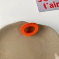 Modern chunky bright orange resin ring with irregular oval shape on ceramic plate - Orange Circle