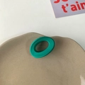 Matte green oval cutout hair claw clip for girls on minimalist ceramic tray - Green Circle
