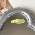 Single matte lime green snap hair clip on a heart-shaped mirror decorative background - Light Yellow
