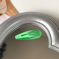 Green matte snap hair clip for girls with a classic oval design on a mirrored surface - Light Green