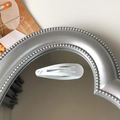 Minimalist matte white teardrop BB hair clip on a silver heart mirror surface - White