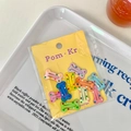 Set of colorful bone-shaped hair clips with polka dots on a yellow display card - Bone Style