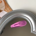Single rose pink glossy lacquered metal snap hair clip for kids on a silver mirror background - Peach Red