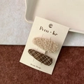 Set of beige sherpa and brown checkered fabric hair clips on a branded display card - Plush Large Drop + Plaid Drop