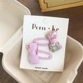 Set of two fabric bow hair clips for kids featuring solid purple and green floral prints - Pink Series