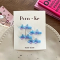 Set of four blue gradient resin butterfly hair clips on white handmade display card - Blue
