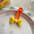 Lindo clip para el pelo con lazo amarillo y naranja y diseño ondulado en un plato - Serie Amarilla