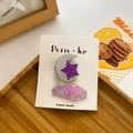 Glittery purple star and moon hair clips set with laser finish on a wooden display - Moon