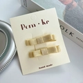 Juego de dos pinzas para el cabello con lazo de cuero dorado brillante en tarjeta - Lazo de Tela de Doble Capa