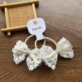 Pair of cream lace bow hair ties with silver ribbon on brown wood background - Lace Trim Bow / Two-Piece Set