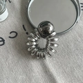 Silver metallic spiral hair tie with a large polished chrome bead on grey linen - Gray Large Artificial Pearl Style