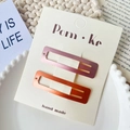 Pair of rectangular gradient pink and orange matte metal hair clips on a display card - Pink And Orange