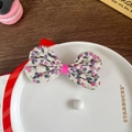 Floral fabric bow hair clip with pink berry pattern and delicate pearl accents - Rose Red Bow Style