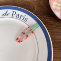 Pink translucent cherry print hair clip with green metal clip on a white plate - Pink Cherry Plaid
