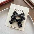 Set of two plaid and floral fabric bow hair clips displayed on a cream card - Black Plaid And Floral Style