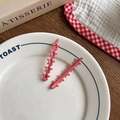 Set of two matte pink star-shaped hair clips for girls displayed on a ceramic tray - Rose Red Star