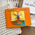 Set de moda con lazo amarillo y horquilla triangular cian en tarjeta naranja - Set de Lazo Amarillo Brillante Y Pinza Triangular Cian