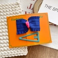 Navy blue fabric bow and teal triangular hair clip set on orange display card - Dark Blue Bow And Teal Triangle Hair Clips Set
