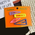 Matte macaron hair clips in purple, yellow, pink and blue on an orange display card - Purple and Yellow