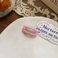 Pink fabric wrapped rectangular hair comb for dogs featuring clear plastic teeth - Pink Large