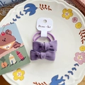 Set of two purple bow fabric hair ties with ribbed texture on a white display card - Purple