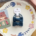 Blue fabric bow hair ties set for girls on a white ceramic display plate - Navy Blue