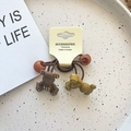 Brown and olive green bear hair ties with golden rhinestones on white card - Bear