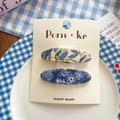 Floral fabric oval hair clips set in beige and navy blue patterns on a white card - Blue Floral