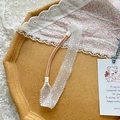 Cute white lace hollow embroidered baby headband with pink elastic strap on cork display - Scale Grid Style