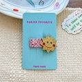 Cute pink glitter smiley sun hair clip for girls on a blue display card stand - Gold Sun