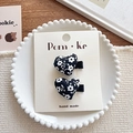 Handmade heart-shaped hair clips with black and white floral pattern on a display card - Black Heart White Floral Hair Clip