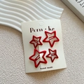 Set of four red star-shaped hollow hair clips for girls on a cream display card - Red Hollow Star Style (NK1195)