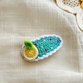 Handmade crochet hair clip featuring a green oval base with dots and a yellow lemon - Bright Green Lemon