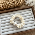 Elegant cream lace hair scrunchie featuring a large white pearl bead on a grey display tray - Beige Pearl