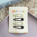 4-piece polka dot BB hair clip set with black and cream star patterns on a white card - Teardrop Polka Dot