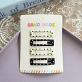 Set of 4 handmade polka dot rectangular hair clips in black and beige on display card - Square Polka Dot