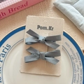 Pair of dusty blue satin bow hair clips for girls displayed on a premium brand card - Blue