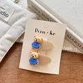 Detail of two cute cartoon bear hair clips on a Korean design display card - Blue Shirt Bear / Off White