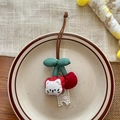 Handmade red cherry fabric keychain with cute cat face and lace detail in ceramic tray - Cherry