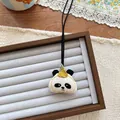 Close-up of cute panda fabric pendant with embroidery and yellow hat on a jewelry tray - Panda Shape (NK1277)