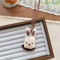 Close-up of rabbit plush pendant with knit texture, brown polka dots and lace strap - Rabbit Shape (NK1277)