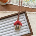 Detail of a handmade cottage charm with red polka dot roof and delicate floral embroidery - House Shape (NK1277)