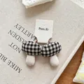 Detail of plaid fabric mushroom hair tie on vintage book with rustic background - Black and White Plaid Mushroom Hair Tie