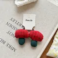 Close-up of handmade red checkered mushroom fabric hair ties on a vintage display card - Red-Green Plaid Mushroom Hair Tie