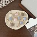 Detail view of colorful Korean-style button hair ties on a ceramic tray display - Light Color Button Hair Tie