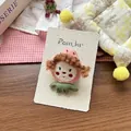 Detailed view of handmade strawberry girl fabric brooch on a white brand display card - Pink Peach Hair Clip