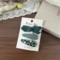 Détail de pinces à cheveux en tissu vert foncé avec broderie florale et nœud classique - Ensemble de 3 / Nuances de vert