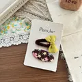 Detail view of handmade fabric bow hair clip and floral pattern oval clip set - Bow And Oval Floral Style