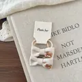 Detailed embroidery of brown bear on beige linen bow hair ties for children - Beige Bowknot Hair Tie