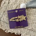 Detail of Korean style golden glitter star hair clip on purple display card - Gold Star